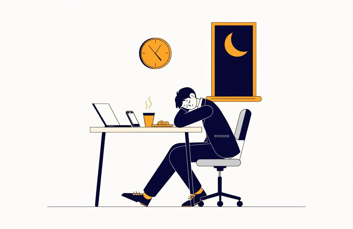 A man in a dark suit dozes on his desk beside a laptop, coffee and biscuits at night